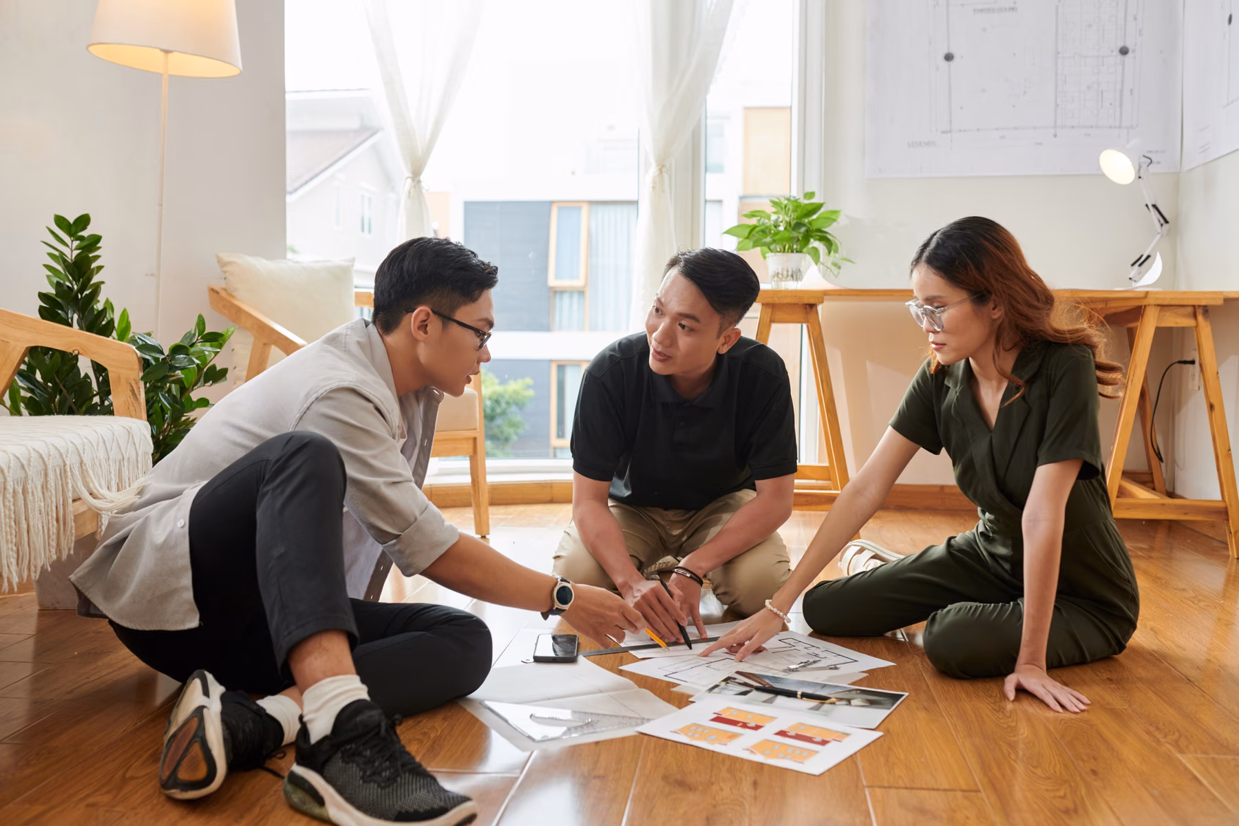 Project team collaborating over a development blueprint
