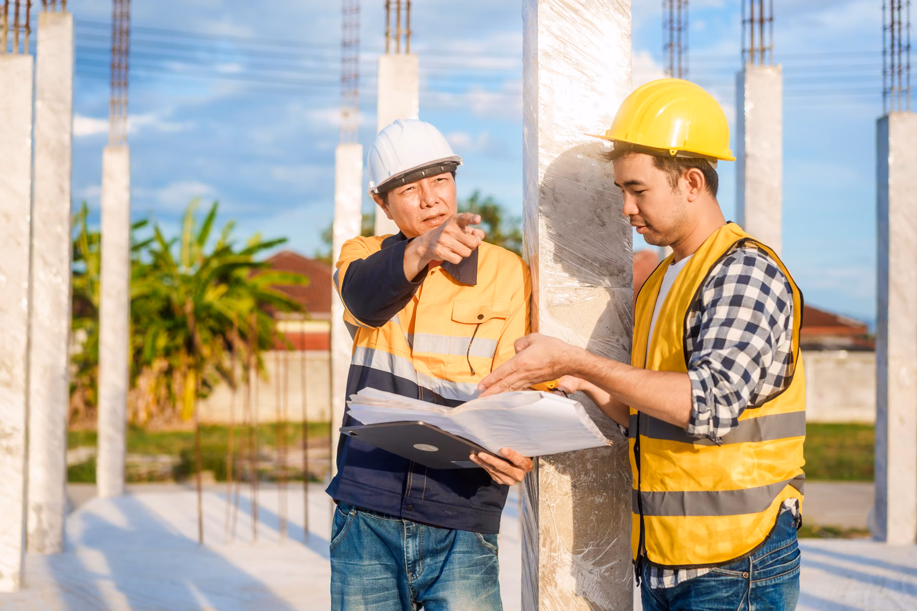 Development team reviewing plans on an active construction site